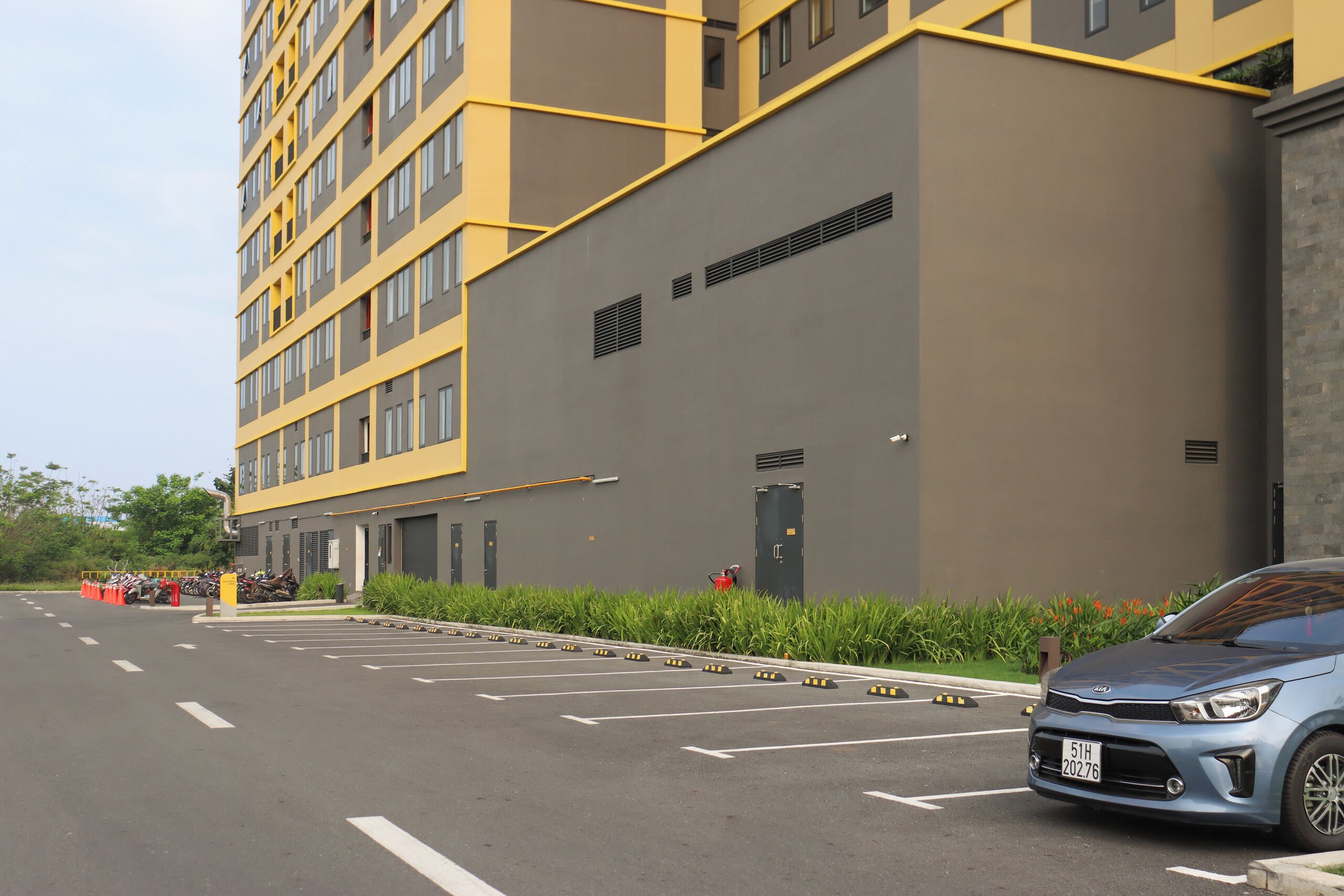A multi-story building with a parking lot in front.