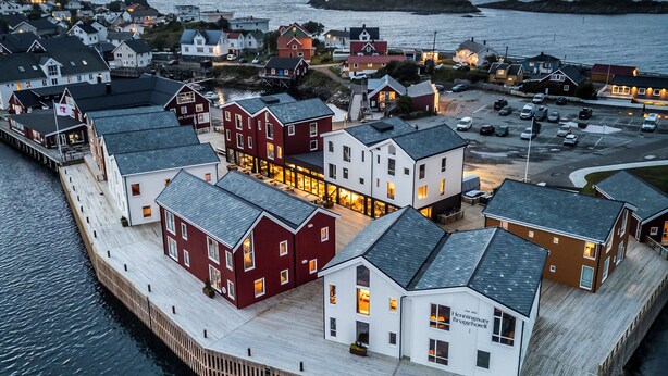 A waterfront property with multiple buildings, including a hotel named 'Henningsvær Bryggehotel'. - Henningsvær Bryggehotell - by Classic Norway Hotels (Vagan)