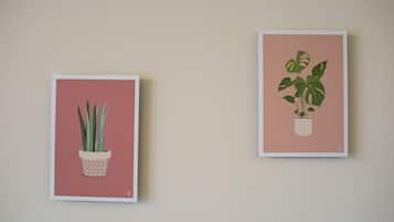 Two framed botanical illustrations on a wall.