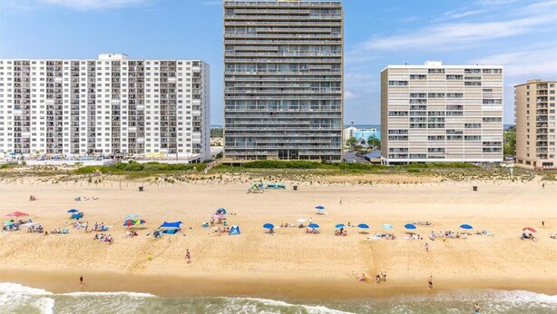 A beach with multiple high-rise buildings in the background. - Century One-Sunny Oceanfront 2 bed/2 bath with Indoor Pool! (Ocean City)