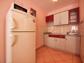 Fridge, microwave, coffee/tea maker, cookware/dishes/utensils