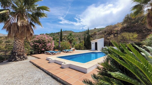 A pool area with lounge chairs, a small white building, and surrounding vegetation. - Beautiful Casa Jade, 3 Bedroom. Private,secluded pool & gardens. Mountain Views  (AN)