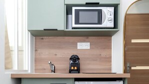 A compact kitchenette with a microwave, coffee maker, and dishwasher. - David D Angers 26 - One Bedroom Apartment, Sleeps 2 (Paris)
