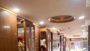 A hotel corridor with wooden doors, a patterned carpet, and a 'Welcome' sign. - Hotel Diva (Istanbul)