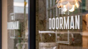 A glass door with the text "THE DOORMAN" in white letters.