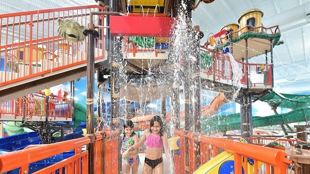 A water slide with two children running down it.