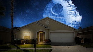 A residential house with a garage, a front door, and a small front yard. - A Dark Siders dream in Vader's Vacation Villa.  (Davenport)
