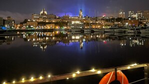 A nighttime cityscape with a marina and boats. - Marina Port de Québec 1 - Maison flottante (Québec City)