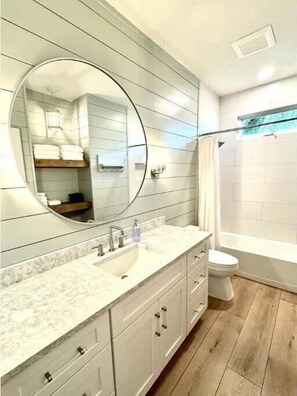 Shower, hair dryer, towels, shampoo