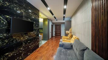 Deluxe Apartment | Living area | 41-inch Smart TV with cable channels