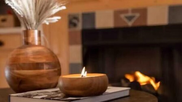 A round table with a candle, a book, and a vase with dried flowers. - Spacious 5 BR w/Mountaintop Views-2 Min to Hunter (Tannersville)
