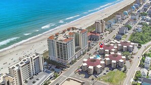 A coastal hotel with multiple buildings, a beach, and a road. - Waipani D13 - Beach is Just Across the Street (North Myrtle Beach)