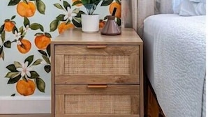 A bedroom with a floral wallpaper, a bedside table with a plant, and a bed with a grey blanket. - Family & Dog Friendly Fun New Renovation w/ Pool!
 (Savannah)