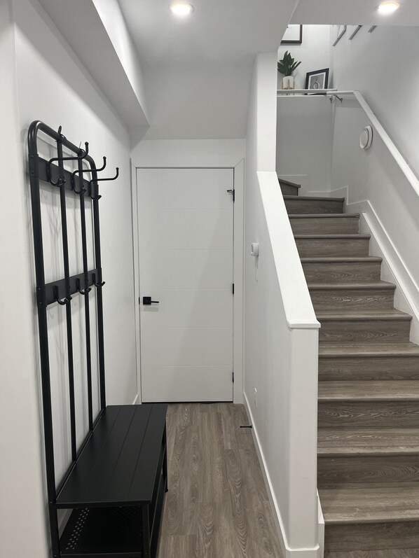 A staircase with wooden steps and white walls.