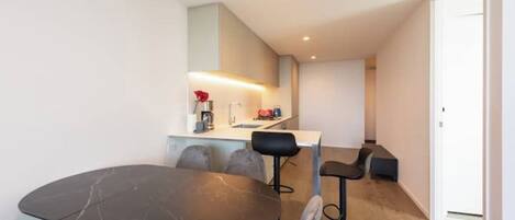 A modern kitchen with a dining area.
