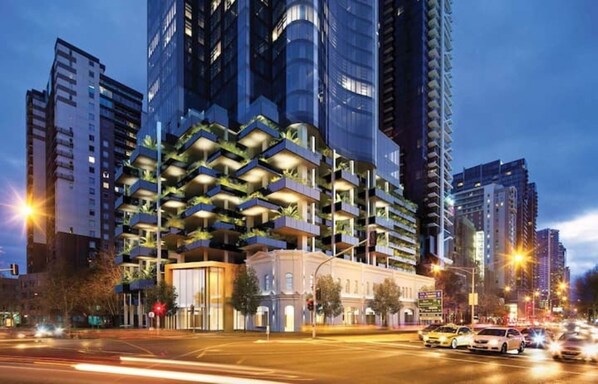 A high-rise building with multiple balconies and a modern architectural design.