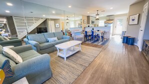 A spacious living area with a sofa set, a coffee table, and a dining table with chairs. - L👀K! NEW LISTING! Lakefront; Boat Ramp. Lake Powell! Rent both sides - sleeps 18 (Panama City Beach)