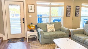 A cozy living room with a green sofa, a white coffee table, and a framed seahorse artwork. - L👀K! NEW LISTING! Lakefront; Boat Ramp. Lake Powell! Rent both sides - sleeps 18 (Panama City Beach)