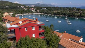 Une ville côtière avec un bâtiment rouge doté de balcons et d’une antenne parabolique.