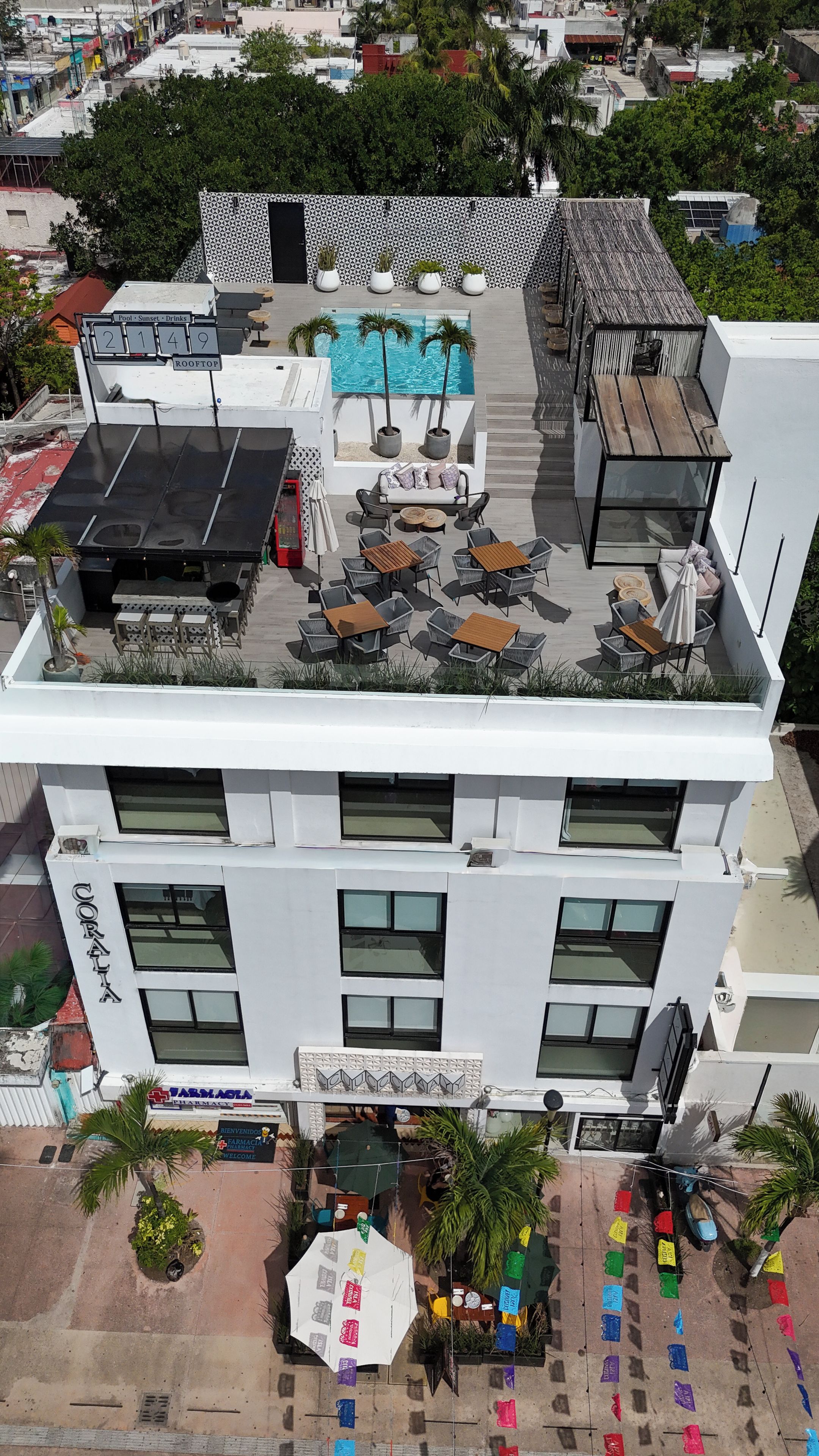 A rooftop with outdoor seating, a pool, and a pharmacy.