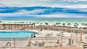 A pool area with a view of the beach and ocean. - Beach Front, First Floor at Jetty East! One FREE Beach Chair Set Up Daily! (Destin)
