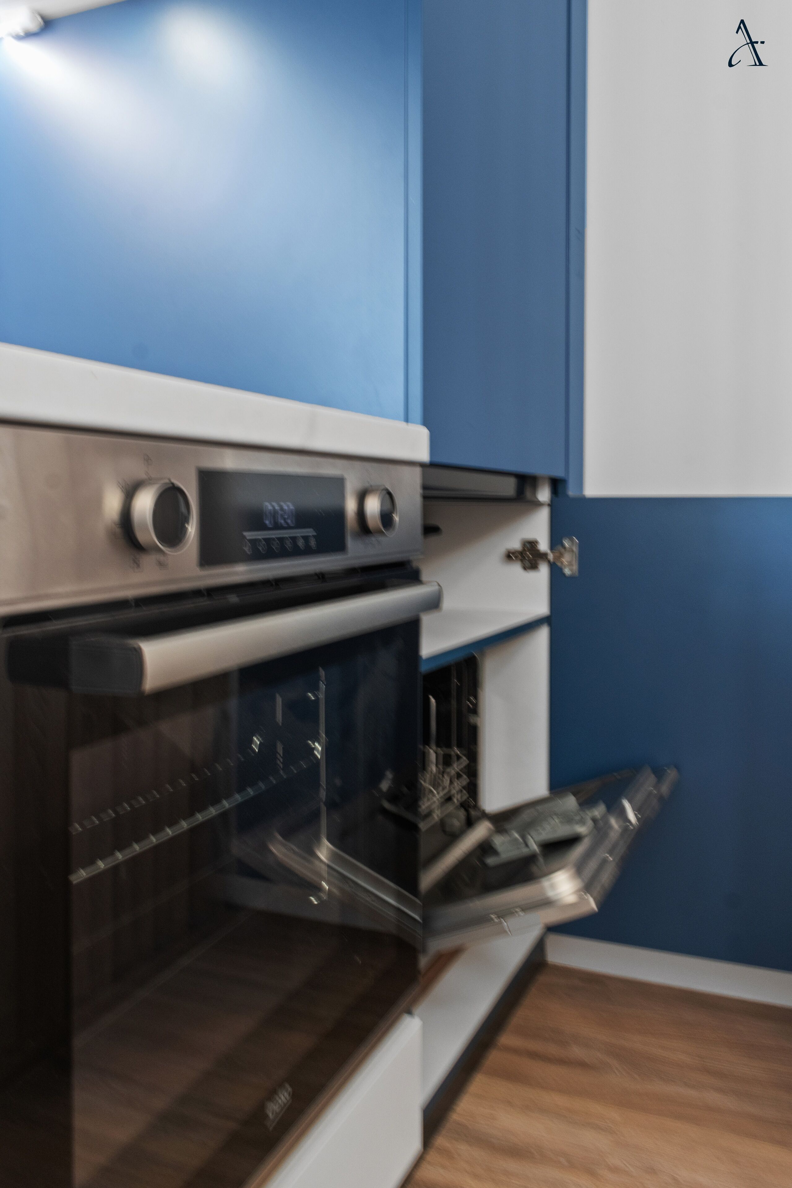 A kitchen with a built-in oven and a microwave.