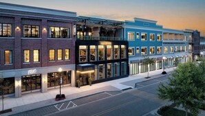 A row of modern hotels with large windows and a flat facade. - Ada Hotel (Ada)