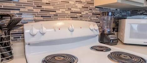 Fridge, dishwasher, coffee/tea maker, cookware/dishes/utensils