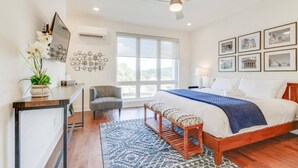 A modern bedroom with a large bed, a desk, a chair, and a bench. - Prime Nashville Getaway – Peaceful Area (Nashville)