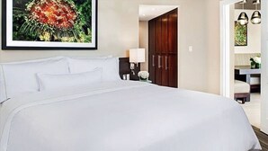A hotel room with a large bed, a nightstand with a lamp, a wardrobe, and a framed picture on the wall. - Luxury 2 BR Coral Vista Villa - Westin St John (Cruz Bay)