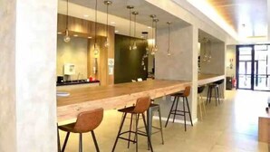 Une cuisine moderne dotée d’un long comptoir et de tabourets de bar.
