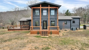A two-story house with a wooden deck and a large window. - NEW 6 Bedrooms - Two houses and a pavillion on Chickamauga Lake with new dock
 (Decatur)