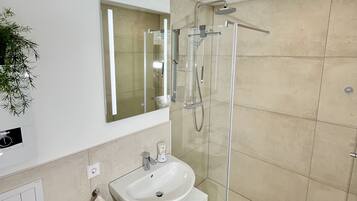 Shower, hair dryer, towels, toilet paper