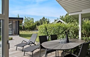 Enjoy al fresco dining on the covered patio with a glass door leading to the interior.