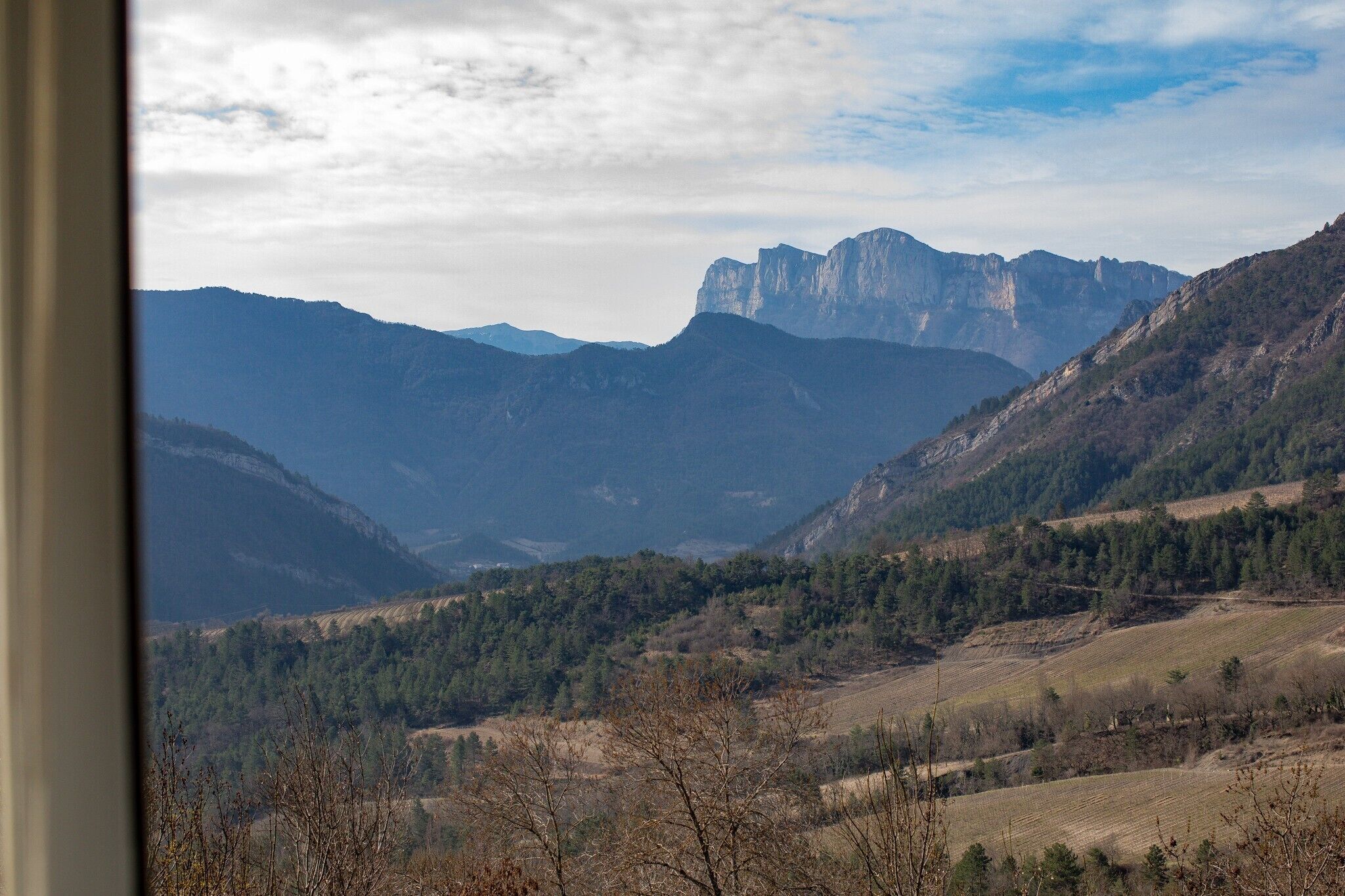 A mountainous landscape with a prominent rocky peak in the background.