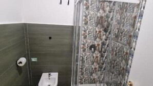A bathroom with a shower, a sink, and a toilet. - The Fondaco At The Historical Archives (Napoli)