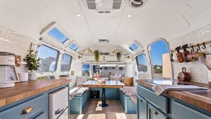 A compact kitchen with a central island, built-in appliances, and a window for natural light.