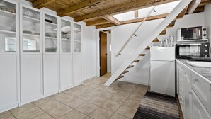 A modern kitchen with white cabinetry, a built-in microwave, and a stainless steel refrigerator. - 1 bedroom awesome apartment in Grevinge (Grevinge)