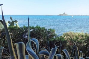 Enjoy breathtaking views of the sea and a nearby island from this serene coastal setting.