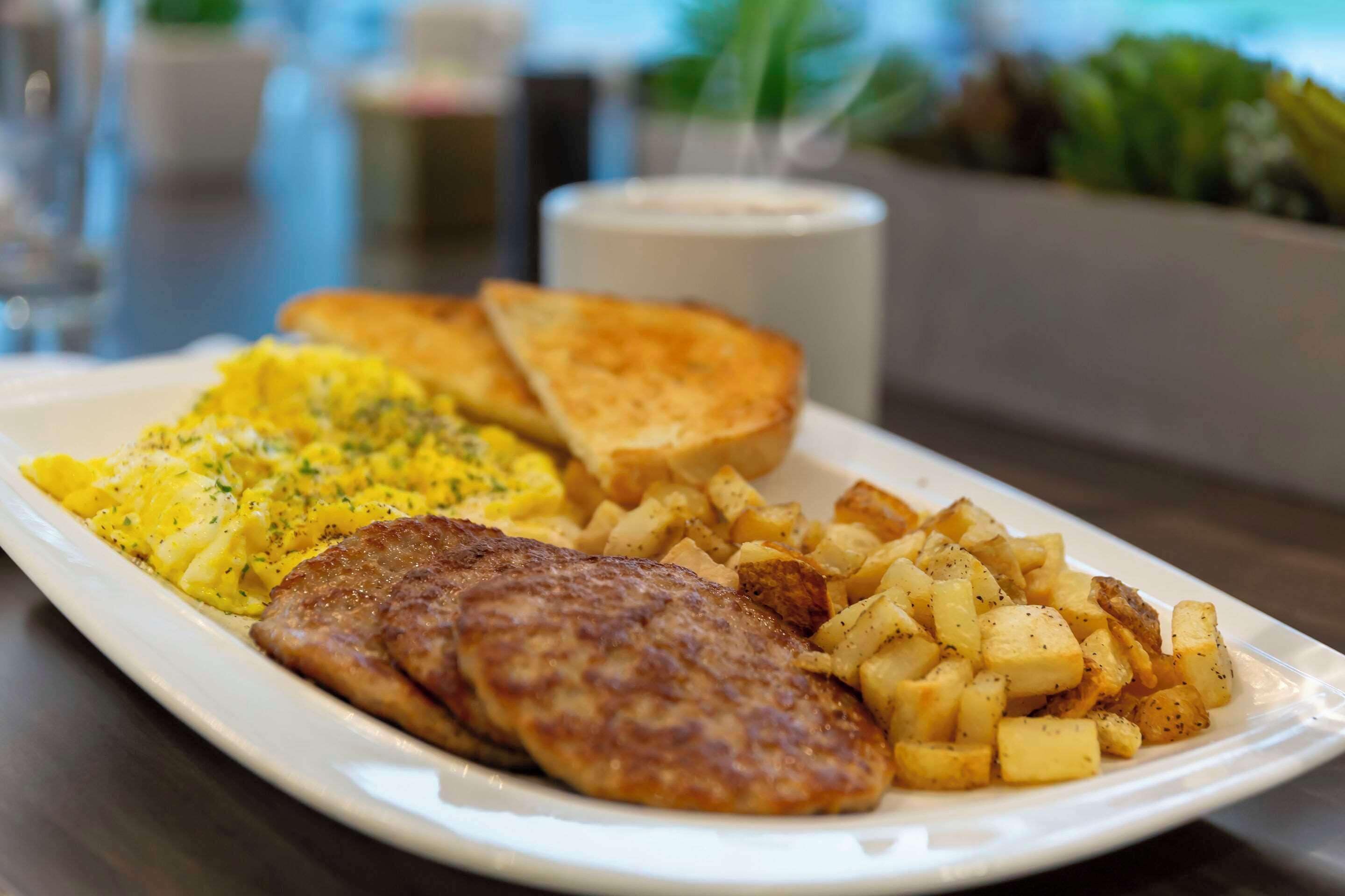 A plate of food including eggs, toast, and potatoes.