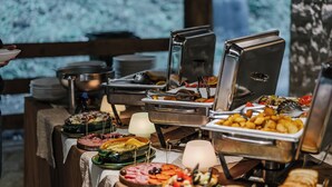 Ein reichhaltiges Buffet mit verschiedenen Speisen und einer Kerze auf einem Tisch.