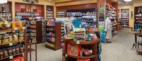 A well-organized grocery store with various aisles of products, including snacks and household items.