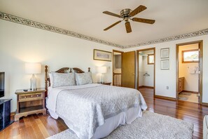 Cozy retreat with a large bed, nightstand, and television.