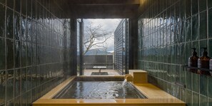 A modern spa with a hot tub, tiled walls, and a view of trees and mountains. - RakutenSTAY FUJIMITERRACE HakoneAshinoko (Hakone)
