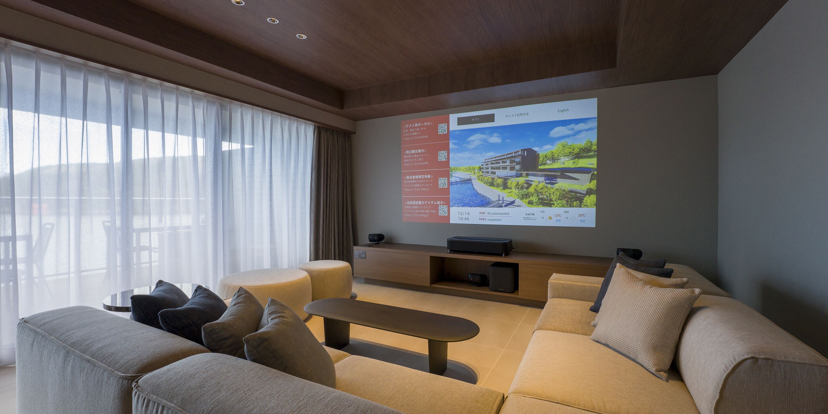 A modern living room with a large flat-screen TV mounted on the wall, a sofa, a coffee table, and a side table.