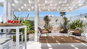 An outdoor patio with a white pergola, wicker furniture, and potted plants. - Beautiful private villa for 10 guests with WIFI, A/C, private pool, TV and terrace (Trapani)