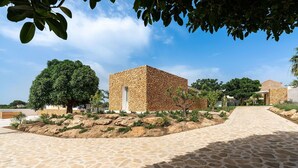 A stone building with a paved pathway leading to it, surrounded by greenery and trees. - Beautiful private villa for 10 guests with WIFI, A/C, private pool, TV and terrace (Trapani)