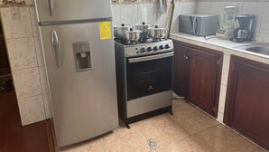 A kitchen with a stainless steel refrigerator, a stove, and a microwave. - Very private and quiet suite with a panoramic view of the entire city.  (Quito)