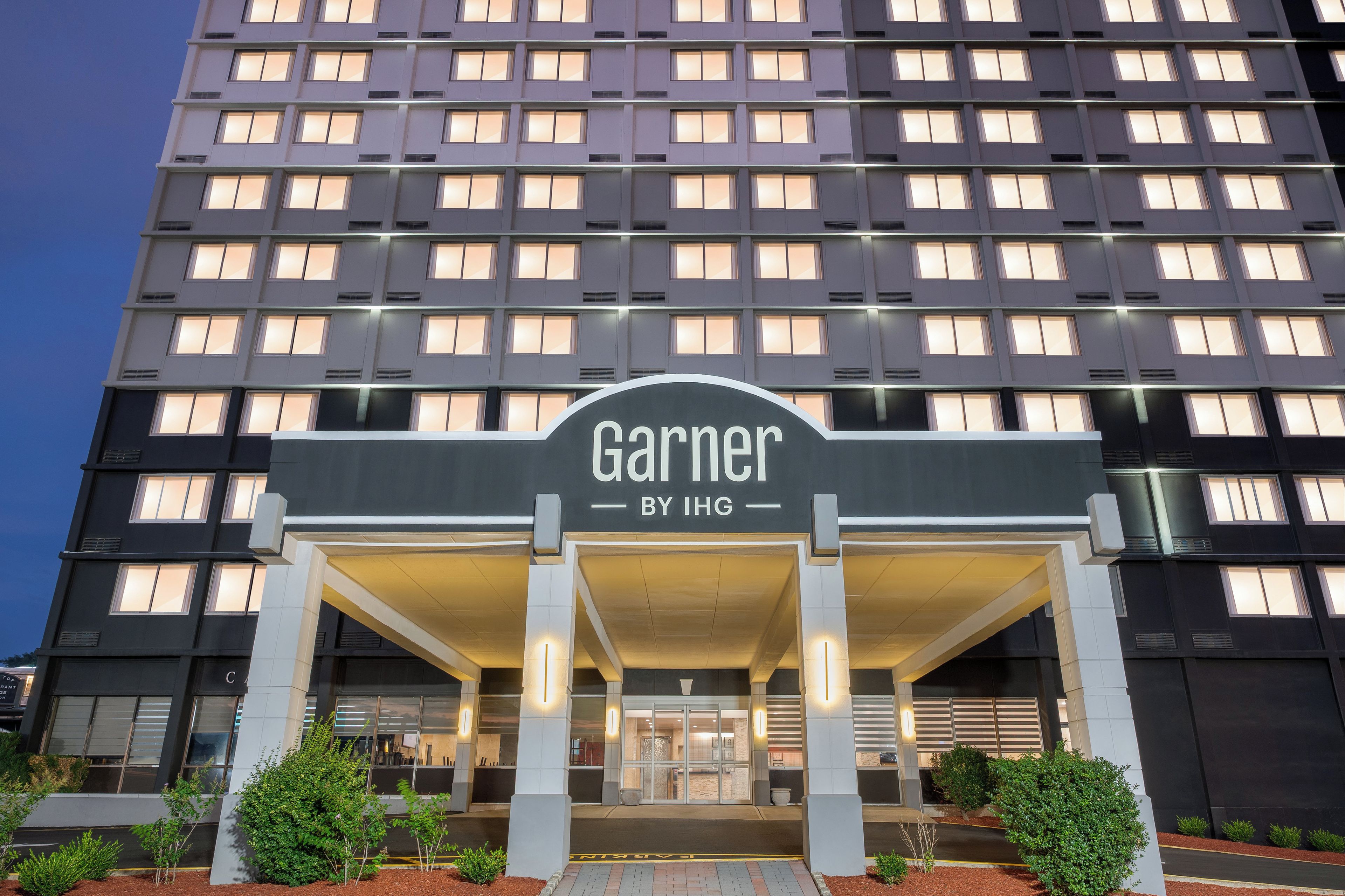 A hotel entrance with a sign reading 'Garner by IHG.'