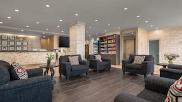 A lobby with seating, a reception desk, and a snack bar.